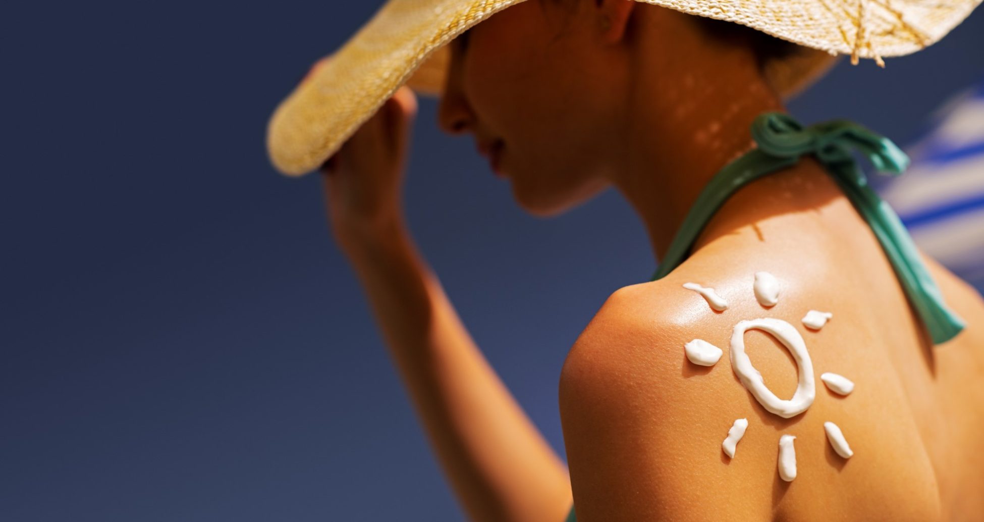 woman-tanning-at-the-beach-with-sunscreen-cream-vishca-skincare-VQB3X65 skin care